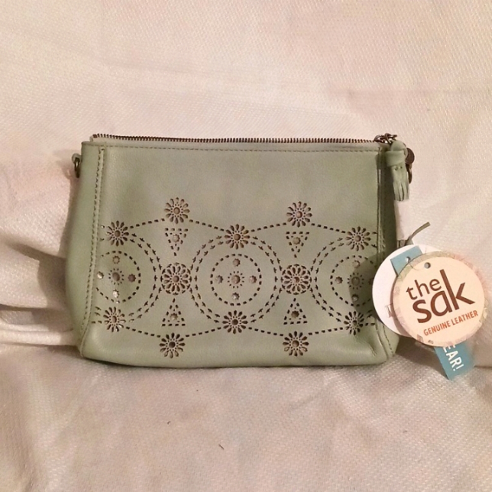 The sak.. light green clutch purse